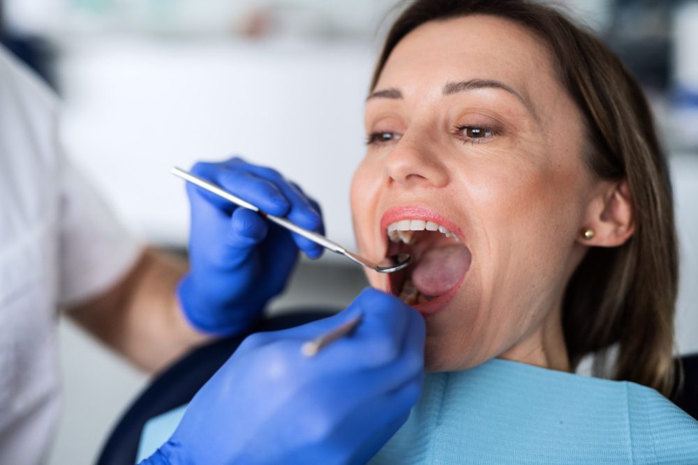 a woman has a dental check up in dentist surgery VAVTZ6Q 1 scaled e1622957958736